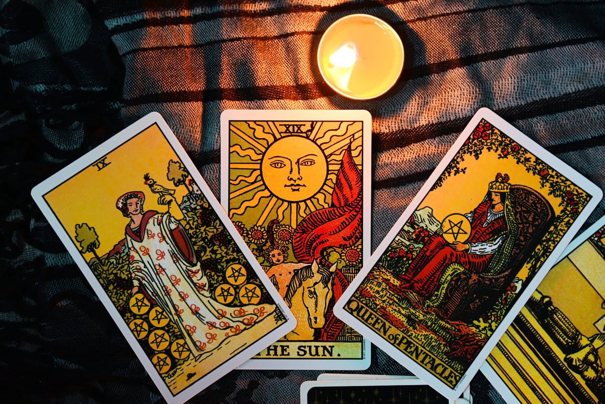 Tarot reading with tarot card background and candlelight on